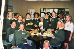 primary students posing for a group photo in the cafeteria