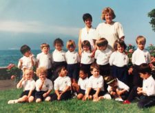 primary students posing for a group photo on the shores of lake geneva